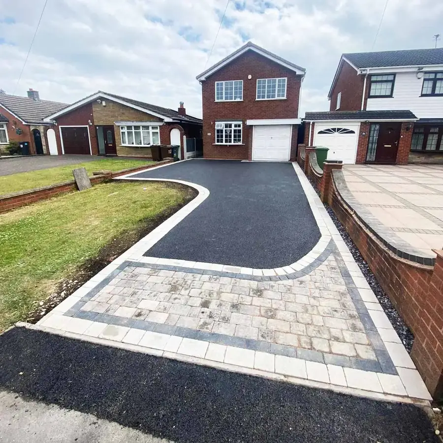 Block paved apron with a pale buff border framing a driveway