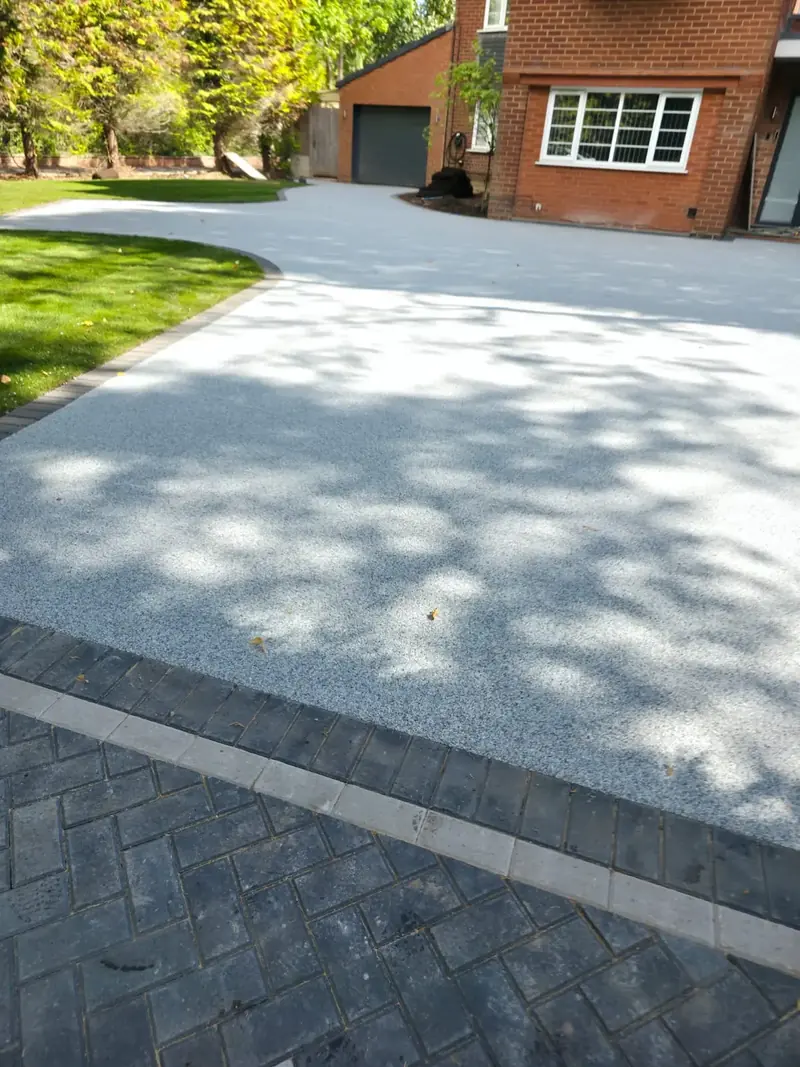 Newly finished paved driveway across the full frontage of a semi-detached house