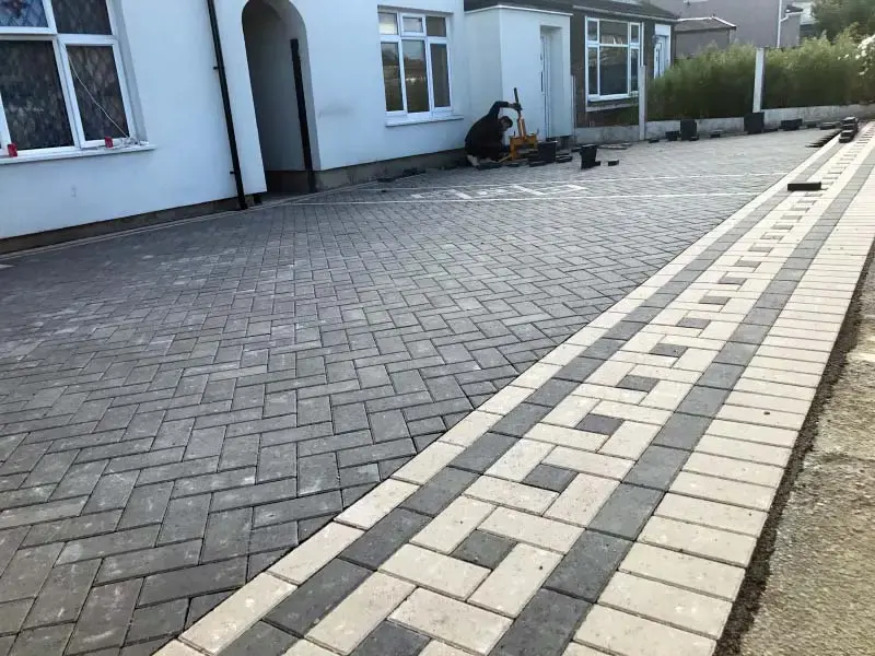 Block paved driveway part-way through installation, showing the charcoal soldier course
