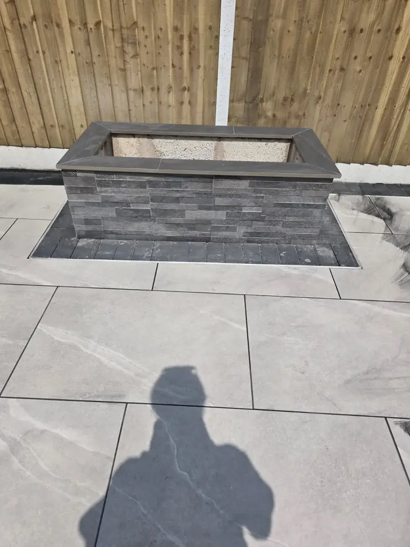 Large-format grey paving slabs with a charcoal block border